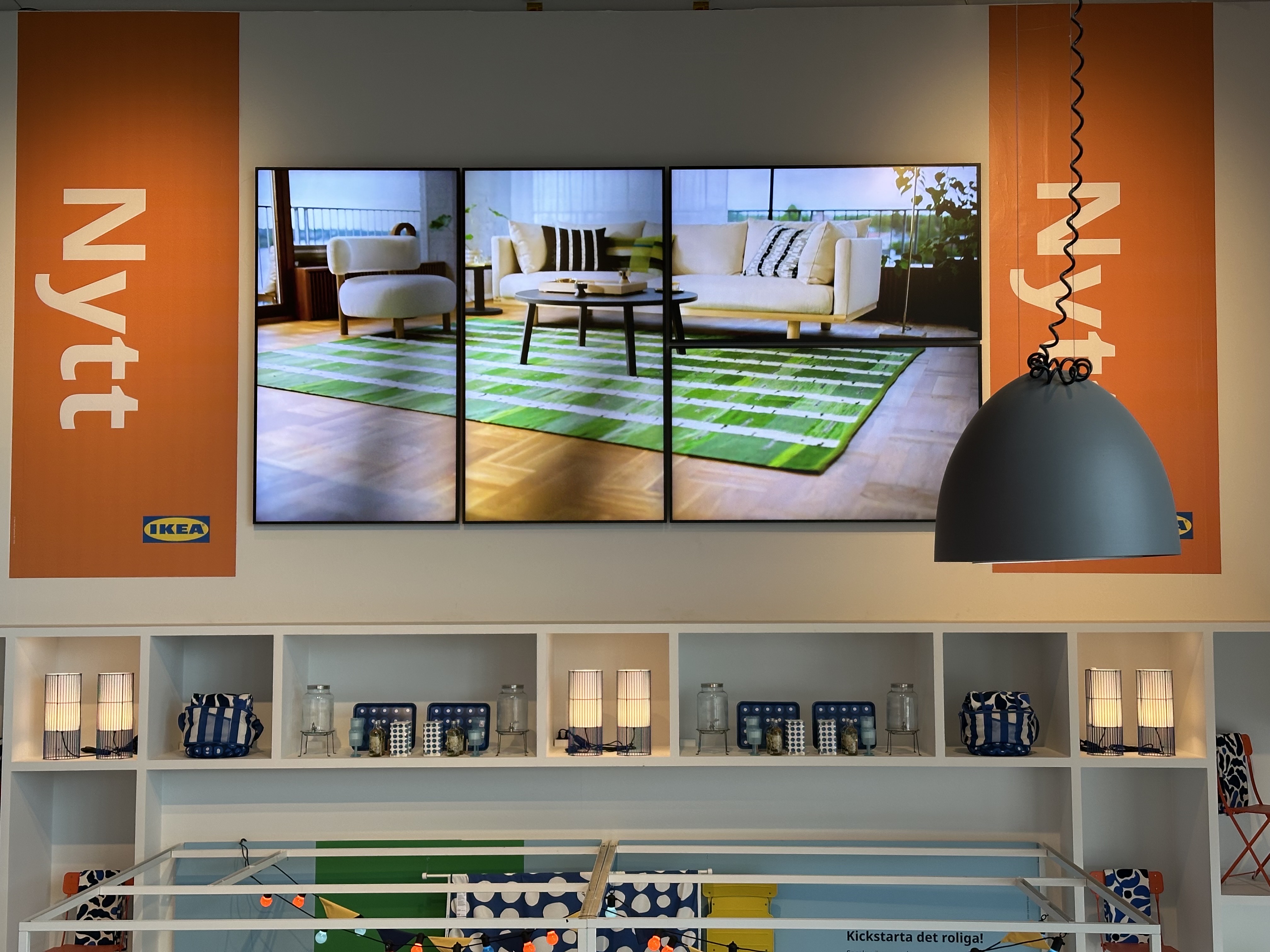 Example IKEA installation - Multi-panel screen showing living room with IKEA furniture in Malmö store